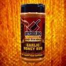 Butcher BBQ Garlic Honey Rub container on a fiery background