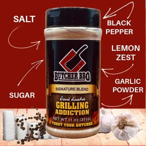 Butcher BBQ seasoning blend with labeled ingredients on a red background