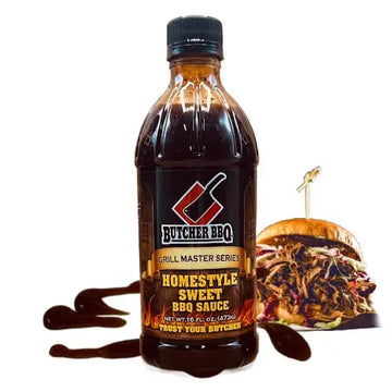 Bottle of Butcher BBQ Homestyle Sweet BBQ Sauce with a pulled pork sandwich in the background