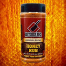 Bottle of Butcher BBQ Honey Rub on a honeycomb background