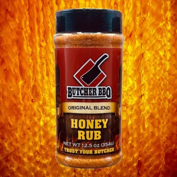 Bottle of Butcher BBQ Honey Rub on a honeycomb background