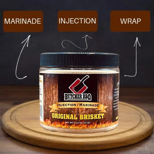 Butcher BBQ Original Beef marinade jar on a wooden board with text labels 'Marinade', 'Injection', and 'Wrap'.