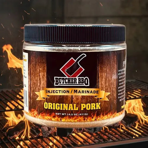 Butcher BBQ Original Pork injection marinade jar on a grill with flames