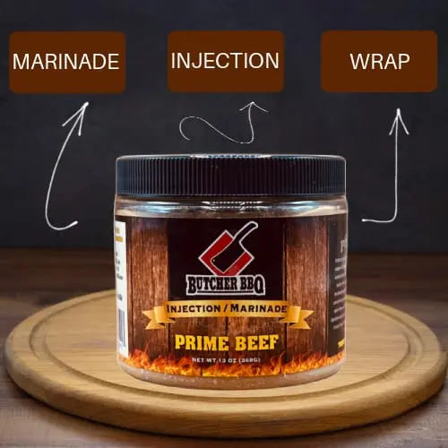 Butcher BBQ Prime Beef marinade jar on a wooden board with text labels 'Marinade', 'Injection', and 'Wrap'.