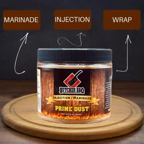 Butcher BBQ Prime Dust marinade jar on a wooden board with text labels 'Marinade', 'Injection', and 'Wrap'.