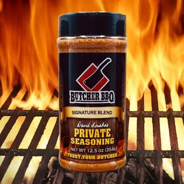Butcher BBQ seasoning bottle with flames in the background
