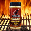 Butcher BBQ Steak & Brisket Rub jar on a grill with flames in the background
