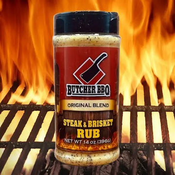 Butcher BBQ Steak & Brisket Rub jar on a grill with flames in the background