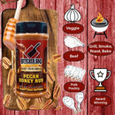 Butcher BBQ Pecan Honey Rub bottle on a wooden board with cooking icons and text on a red background