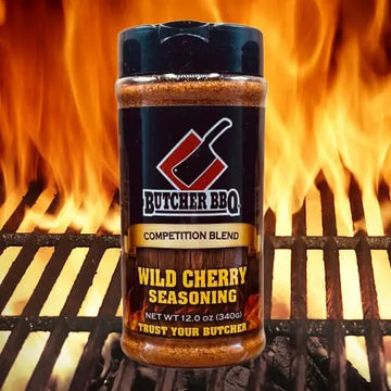 Butcher BBQ Wild Cherry Seasoning bottle with flames in the background